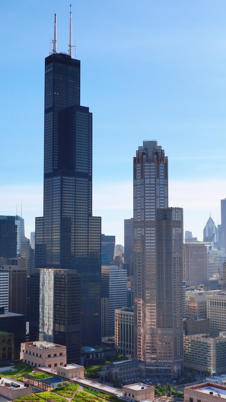 Modern tall towers in downtown Chicago. Sunny summer day with clear sky. Aerial view. Vertical video