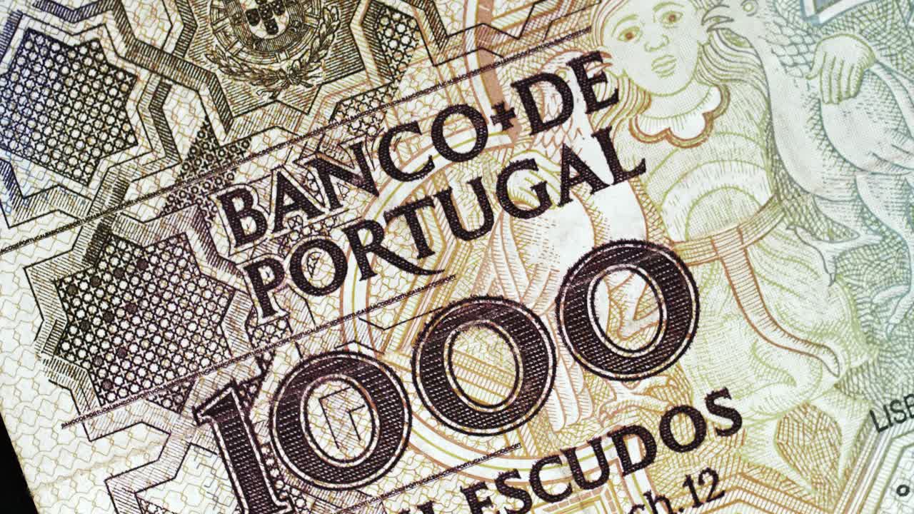Portugal 1000 Escudos banknote obverse with Banco de Portugal text and figure detail rotating on black background