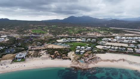 Chileno-Bay-Beach-with-blue-waters-and-a-cloudy-sky,-Cabo-San-Lucas