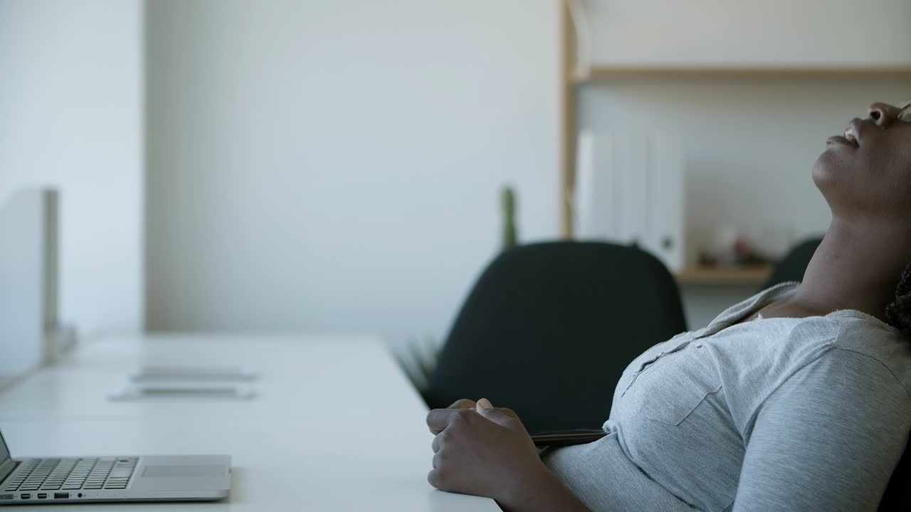 Tired worker sleeping in chair