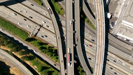 overhead drone shot of intersecting freeways in downtown seattle on a sunny day