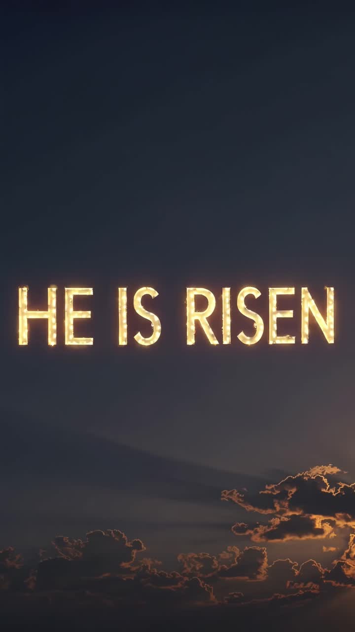 Inspirational video with a low-angle view of a dramatic sky and glowing text 'He Is Risen,'