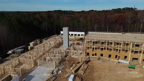 construction site development requires complex framing heavy machinery operations and tools. an aerial view of a large construction site demonstrating framework and heavy machinery used for new builds