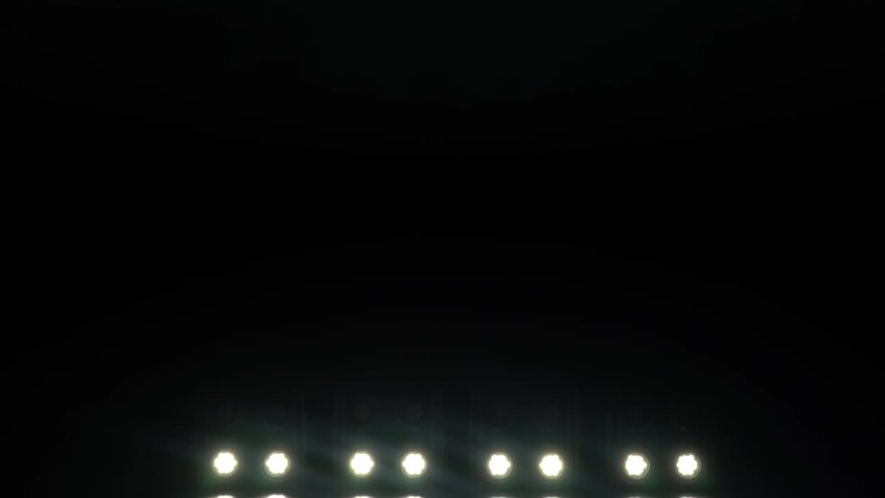 Light from the spotlights through the smoke on stage during a performance or show