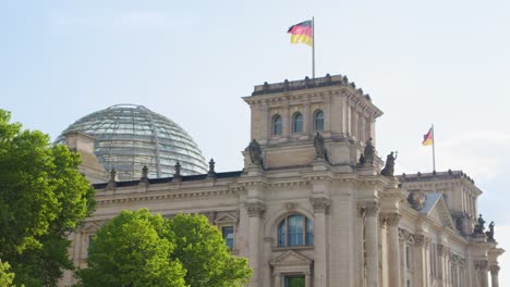 Reichstag-Building-in-Berlin-with-Glass-Dome-and-Waving-Flag,-Closeup