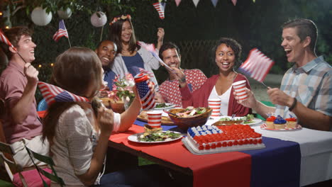 friends celebrating 4th of july with backyard party
