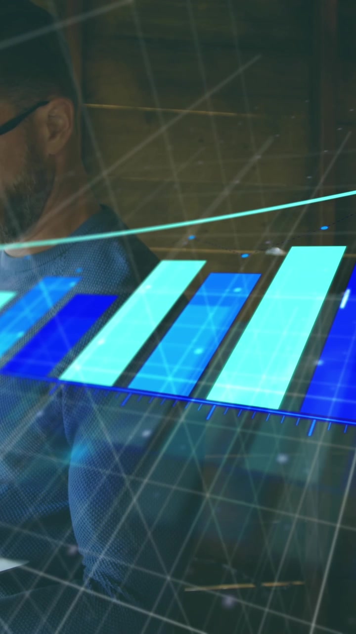 Animation of arrow and graph over serious caucasian man standing and working on laptop