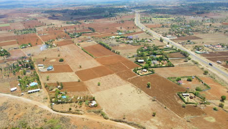 jib down of a beautiful landscape with farms in rural kenya, africa