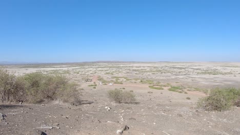 Safari-trip-cars-in-savanna-dry-grass-and-red-soil-landscape,-Amboseli-National-Park