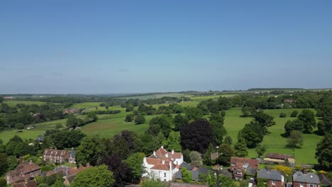 Drone-shot-flying-close-the-weather-vine-of-the-village-church-in-Barham-in-Kent,-UK