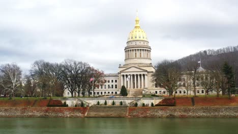 west virginia state capitol in charleston with drone video moving with river view