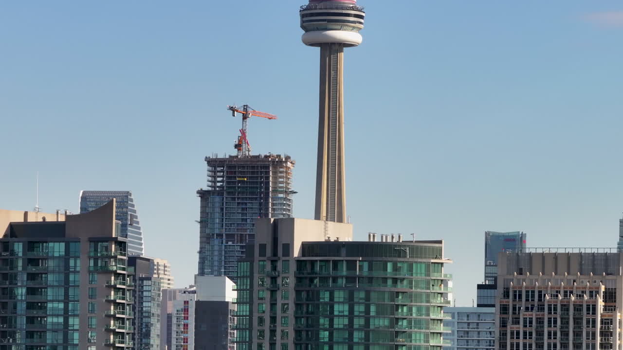 drone aerial shot revealing the CN Tower in the downtown cityscape of Toronto
