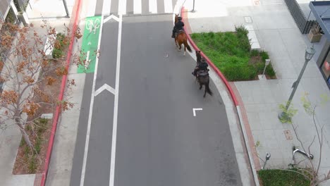 mounted police officers patrolling city streets