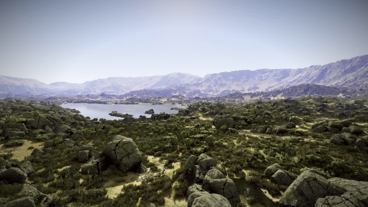 Expansive landscape view with a serene lake surrounded by mountains