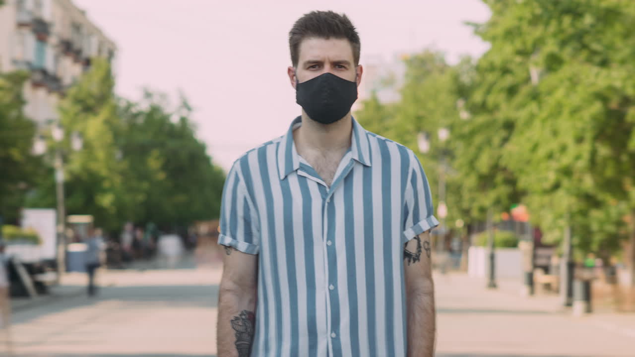 Man wearing a mask on a city street