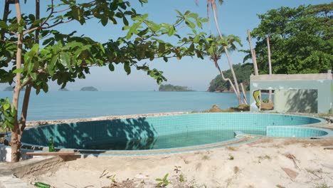 static-shot-of-a-empty-swimming-pool-at-a-abandoned-beach-resort-on-in-Thailand