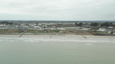 Aerial-Sideways-View-Of-Stunning-Rosslare-Town-And-Beach-In-Wexford,-Ireland