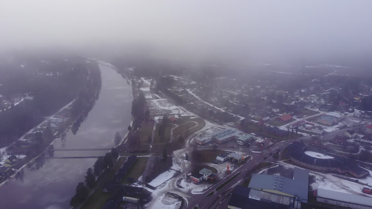 aerial shot of road E16 passing thru Vansbro on thier way to the Sälen ski area. The calm Västerdalälven to the left as clouds moving past.