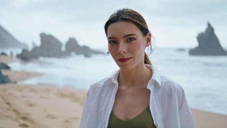 pensive woman standing beach closeup vertical veiw. portrait of thoughtful girl.