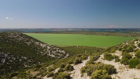 scenic aerial view of drone gliding forwards of cryptodepression waters of naturpark vransko jezero, vrana lake nature park, croatia