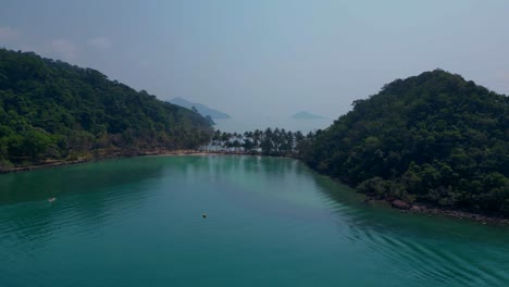 scenic aerial view of lush green hills and turquoise waters on koh chang ngam island. nice aerial view flight static tripod hovering drone