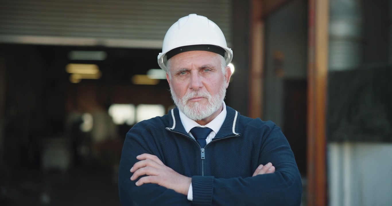 Senior Male Engineer Wearing Hard Hat Standing in Industrial Facility