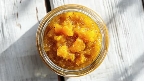 close up of mango chutney in a jar