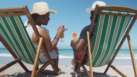 senior couple on deck chairs with cocktails