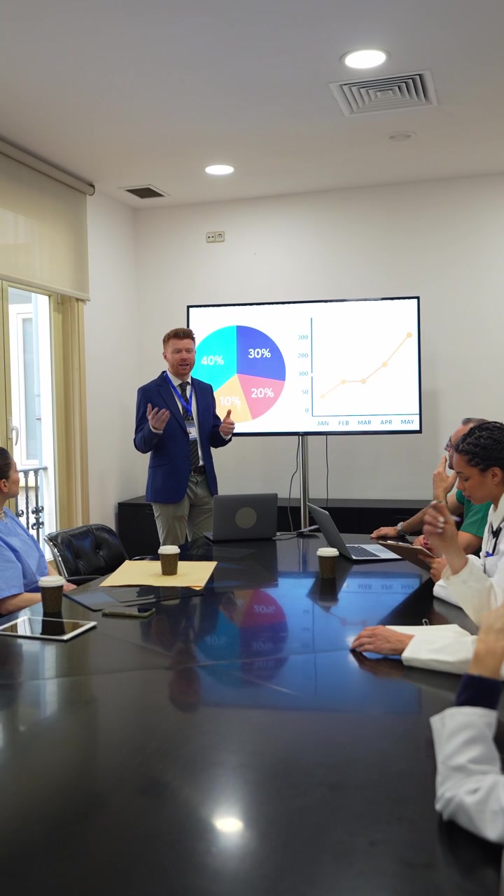Healthcare Professional Presenting Data to Medical Team in Meeting