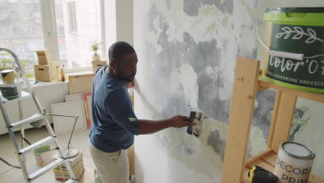 man repairing a wall