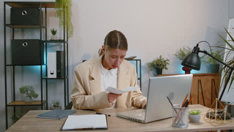 Stressed-businesswoman-looking-at-unpaid-bank-debt-loan-throws-paper-document-bills-financial-crisis