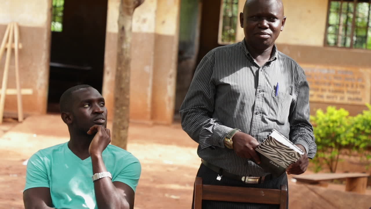 Portrait Of Two African Men Outdoors Giving A Speech. Closeup Shot.