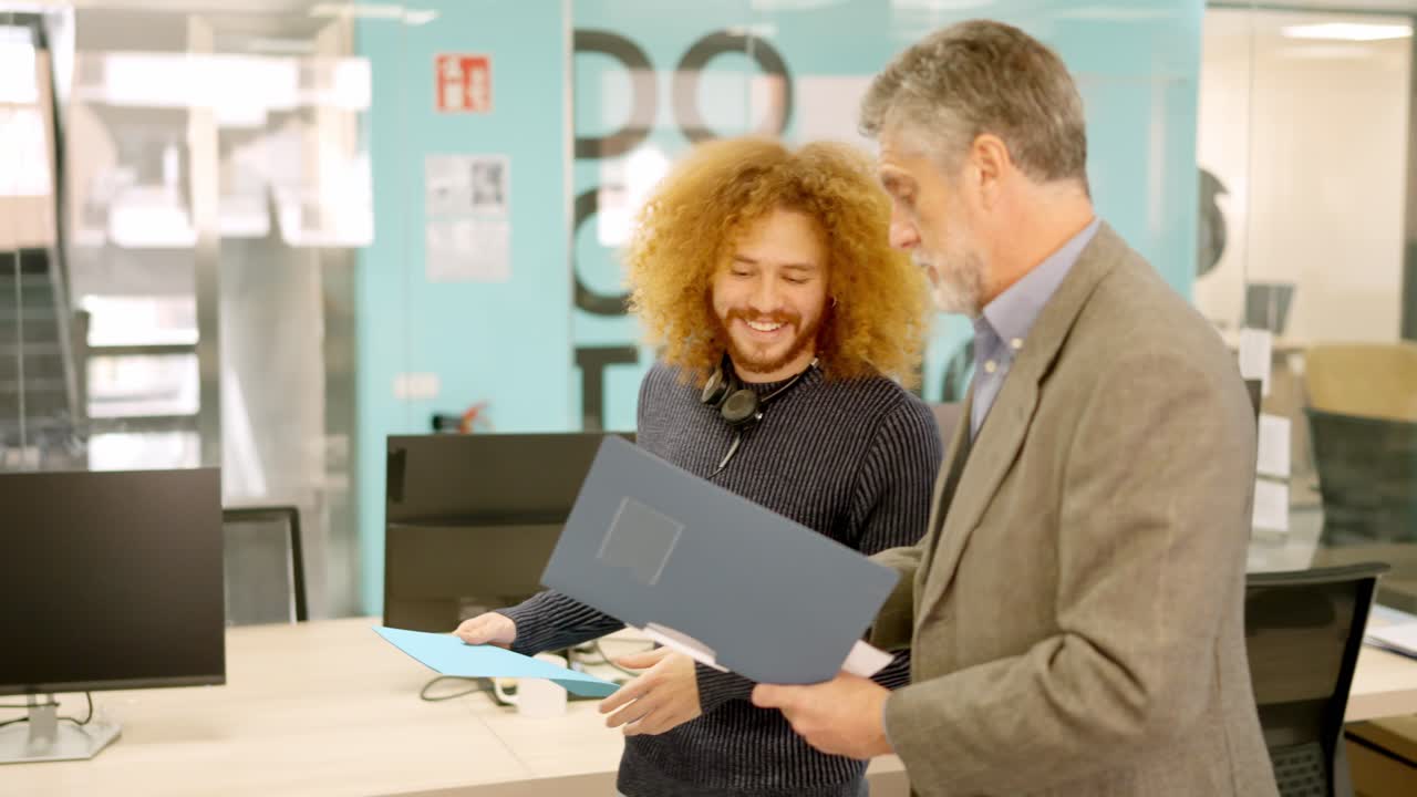 Manager and employee talking about informs in a coworking