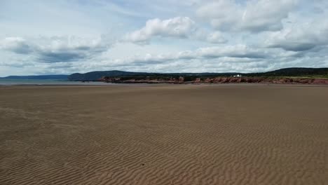 Low-flying-drone-shot-over-Waterside-Beach-heading-towards-Bay-of-Fundy,-New-Brunswick