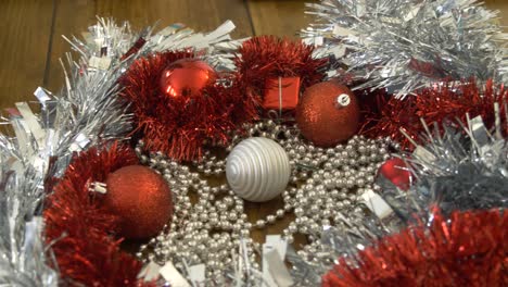 a candy cane falling on a pile of christmas decorations