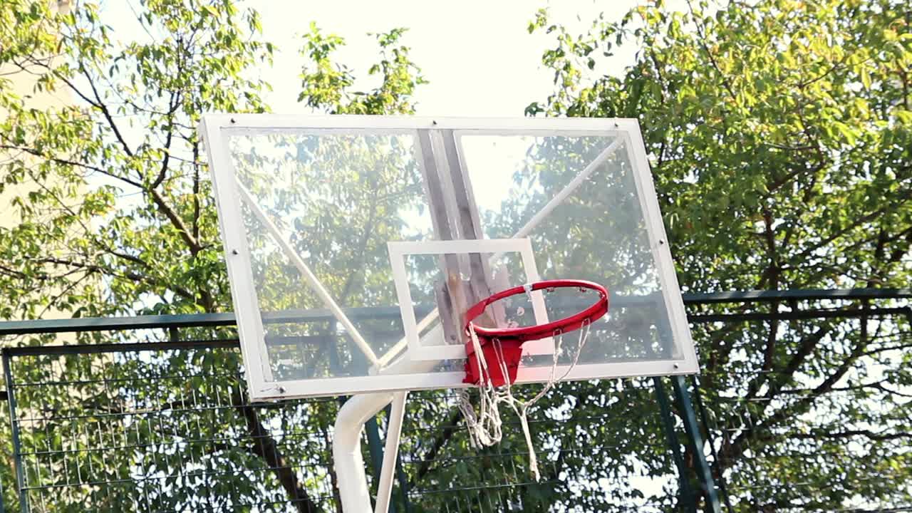joven arrojando una pelota a la canasta