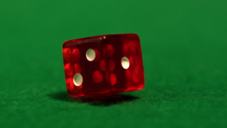 red dice spinning on casino table