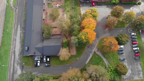 aerial top-down, school building with cars parked