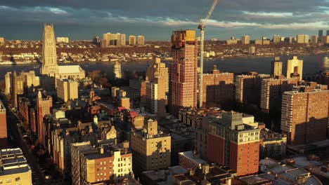 stationary drone shot of morningside heights neighborhood in manhattan, new york city at golden hour sunrise