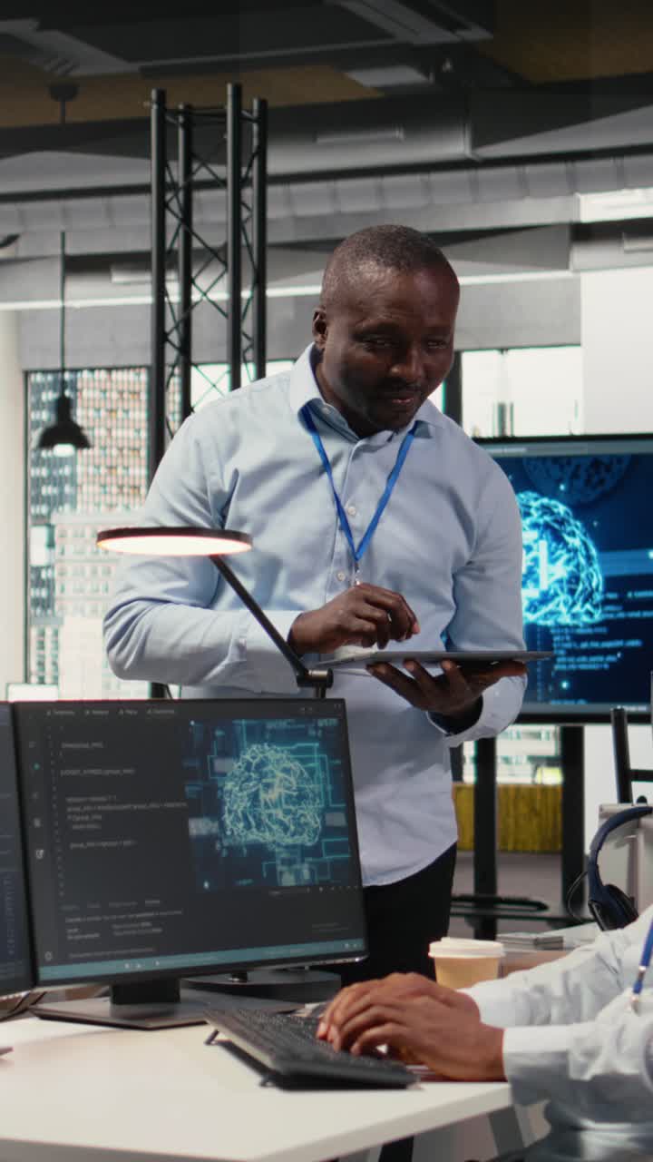 Vertical video Smiling IT staff members in office using AI to optimize company systems