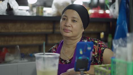 portrait of a woman at a market stall