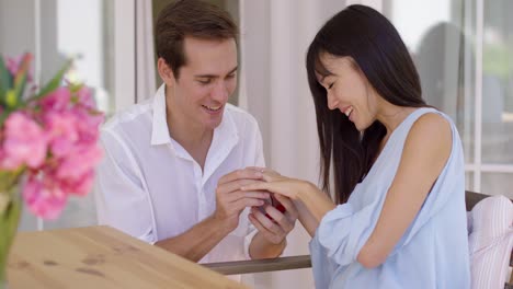 happy young woman accepting a wedding proposal