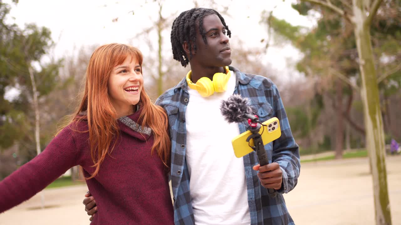 Couple filming a vlog in the park