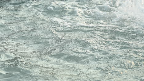 closeup shot of gushing water splashing in the fountain, shot at 120 fps in 4k