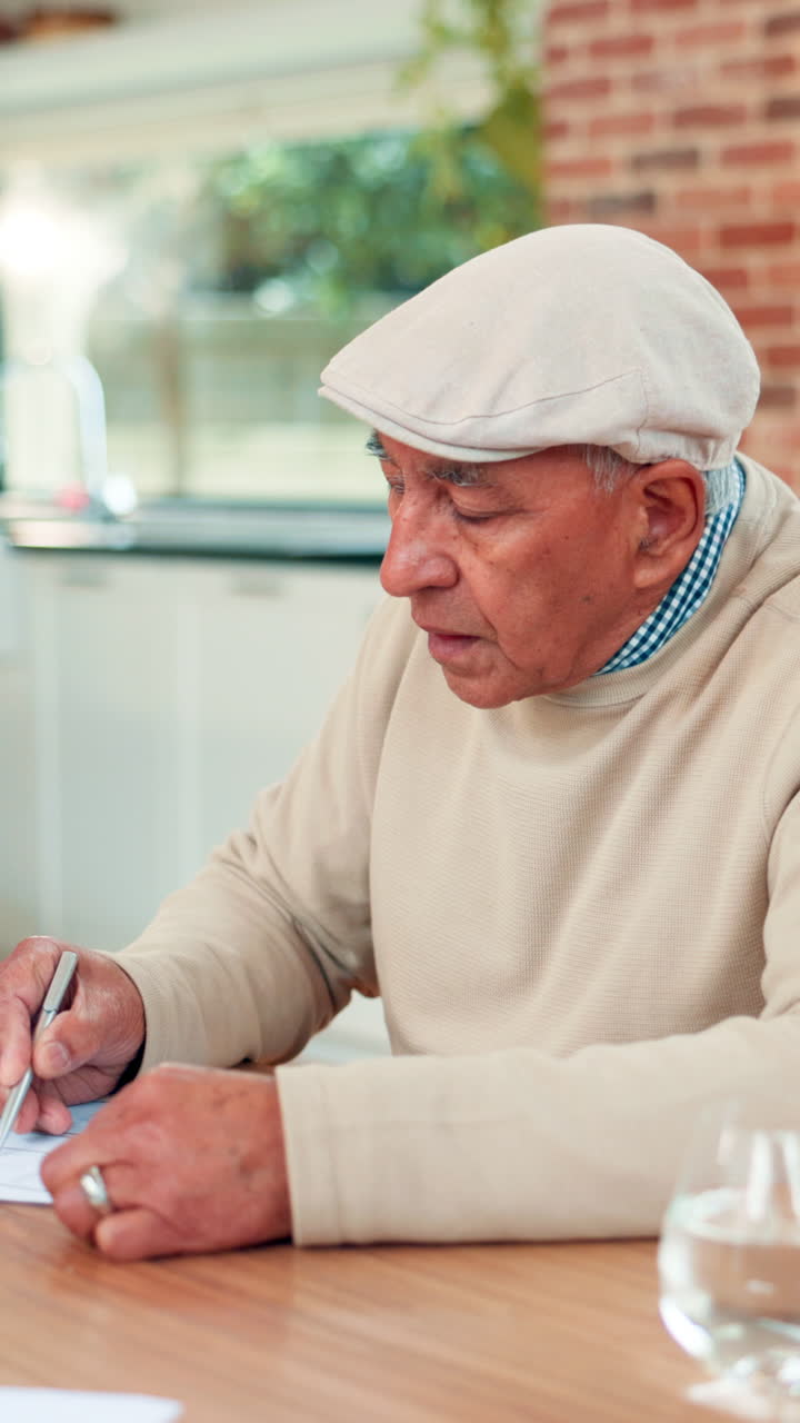 Homem idoso escrevendo no papel em casa e sorrindo