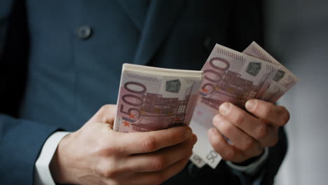 male hands calculating bills european currency close up. man counting banknotes.