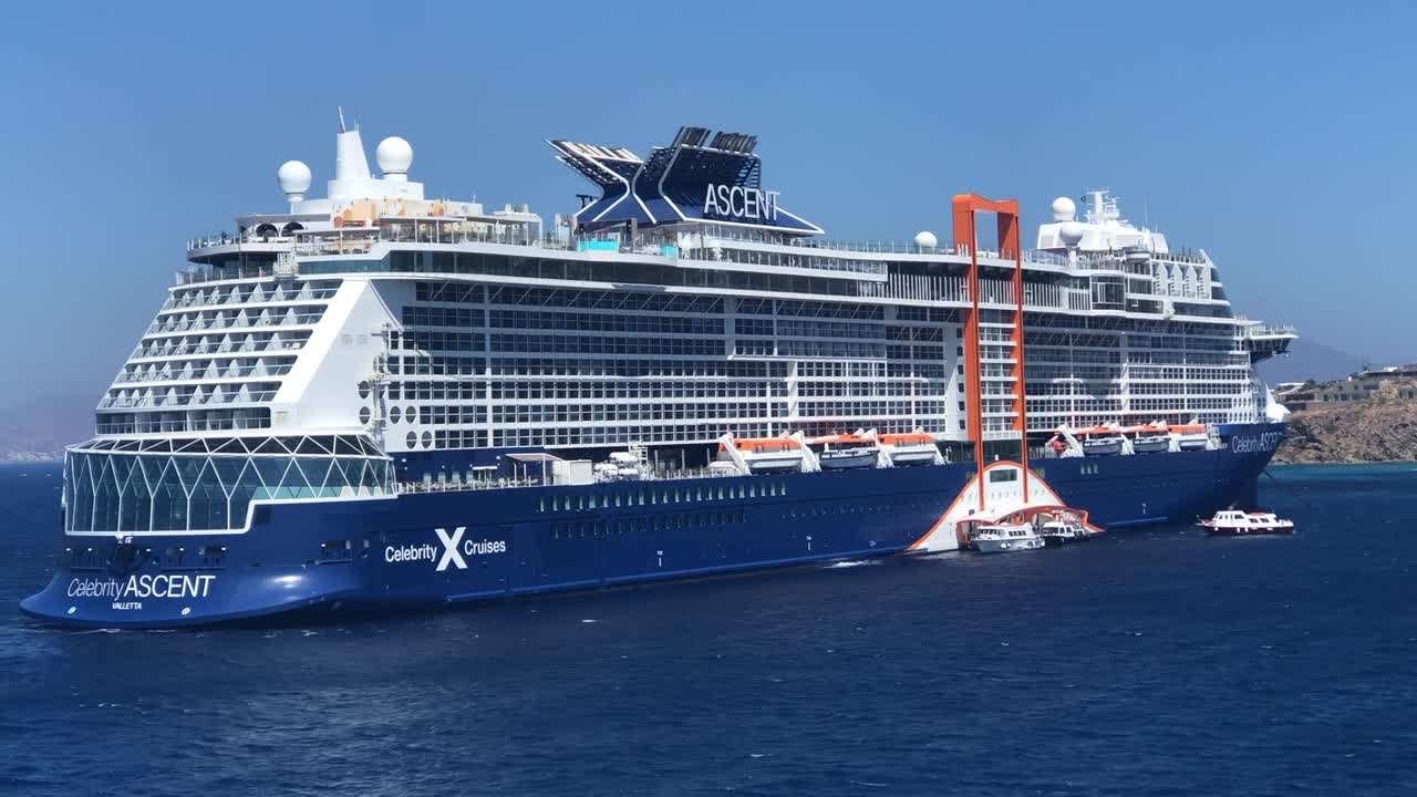 Huge cruise ship anchored in Mykonos port and traveling the Mediterranean sea