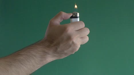 Young-man-turning-on-lighter-in-slow-motion