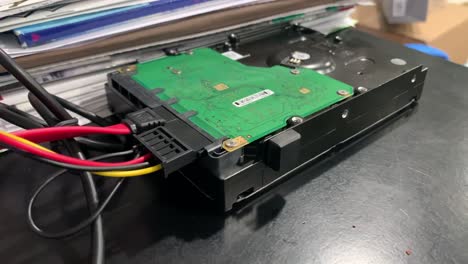 hard rive being recovered on a black desk