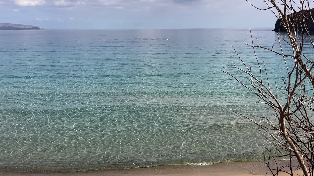 Scenic view of Voulisma Beach with crystal clear waters and a sandy shore in Crete, Greece